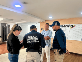 ciudadano francés con circular roja de Interpol junto a oficiales de Migración